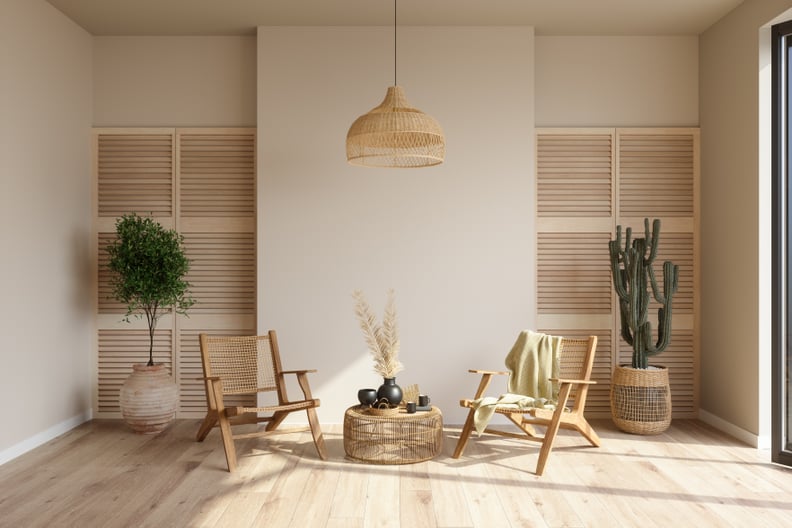 Living Room Interior With Wicker Armchairs, Potted Plants And Coffee Table.